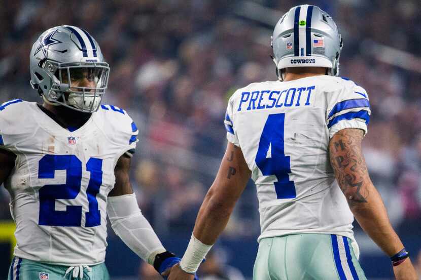Dallas Cowboys running back Ezekiel Elliott (21) and Dallas Cowboys quarterback Dak Prescott...