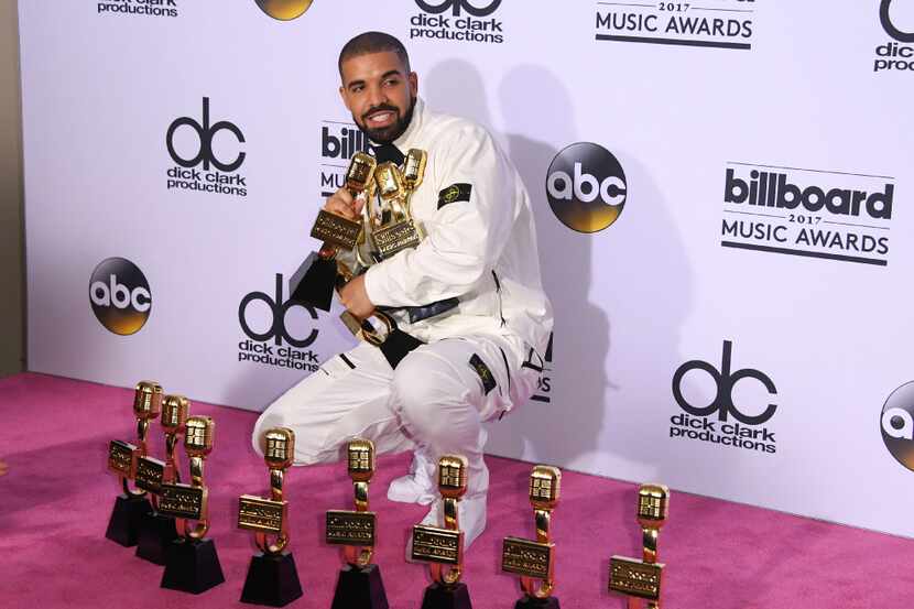 Drake poses in the press room with his awards during the 2017 Billboard Music Awards at the...