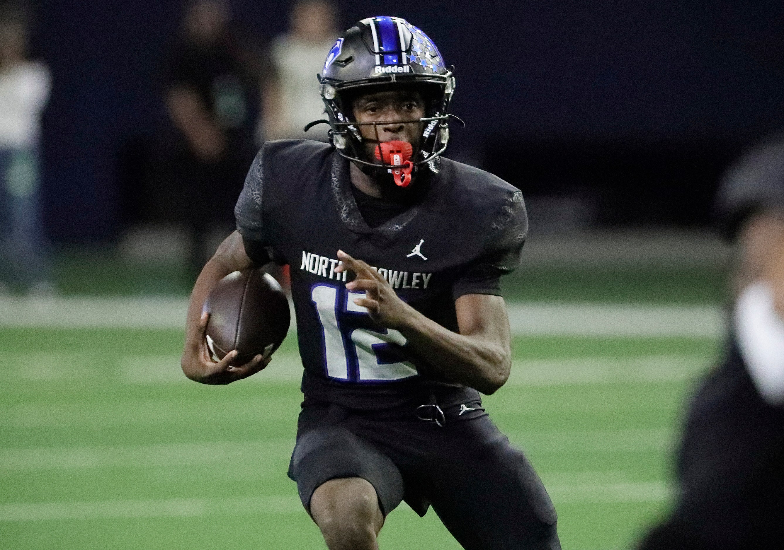 North Crowley High School quarterback Chris Jimerson (12) carries the football during the...