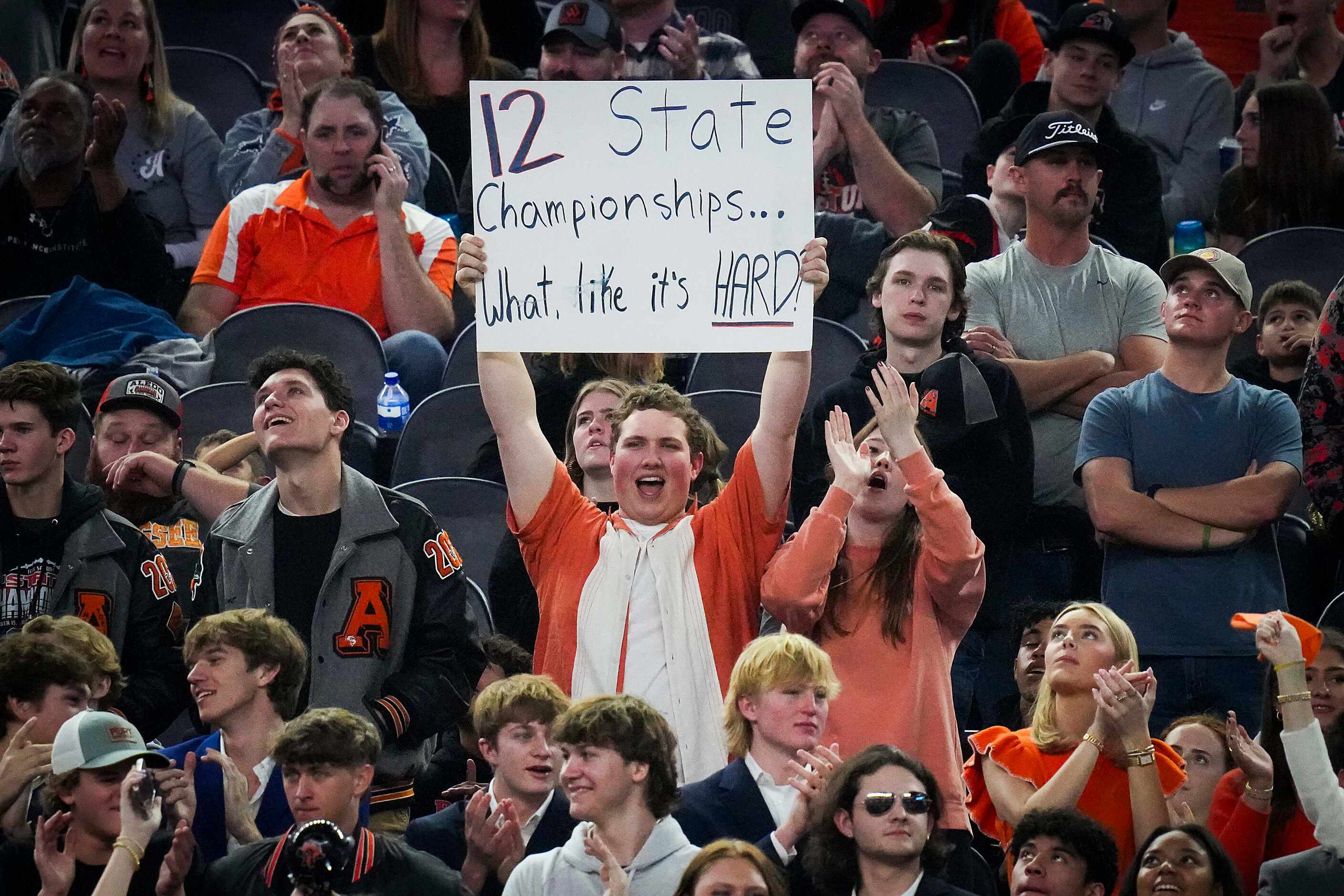 Aledo fans hold a sign cheering the Bearcats to their 12th championship during the second...