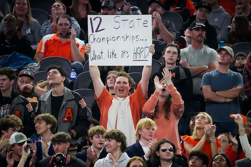 Aledo fans hold a sign cheering the Bearcats to their 12th championship during the second...