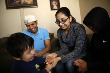  Martha Angelica Romero, wife of RubÃ©n GarcÃ­a Villalpando, plays with her son Avediel...