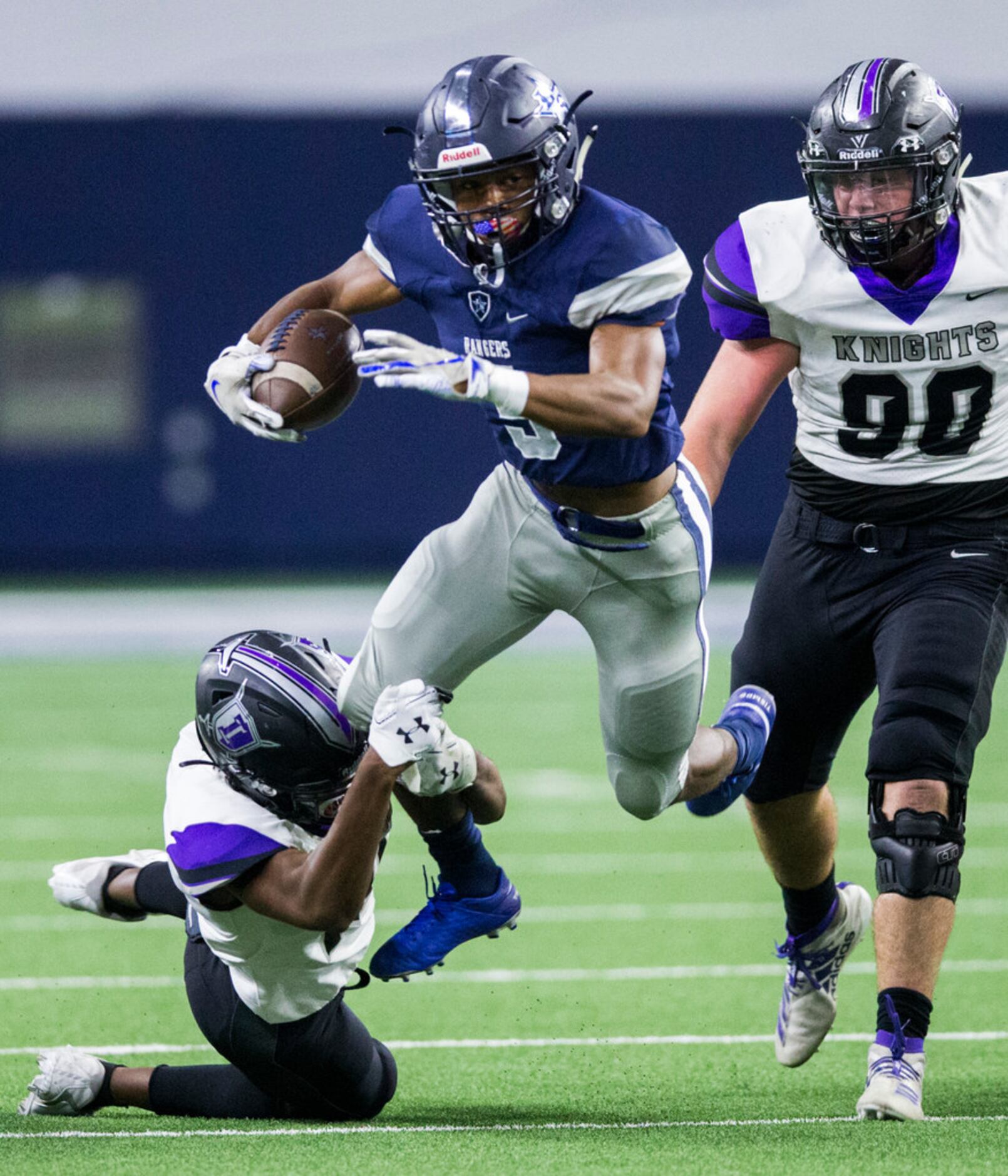 Frisco Lone Star running back Jaden Nixon (5) is tripped up by Frisco Independence defensive...