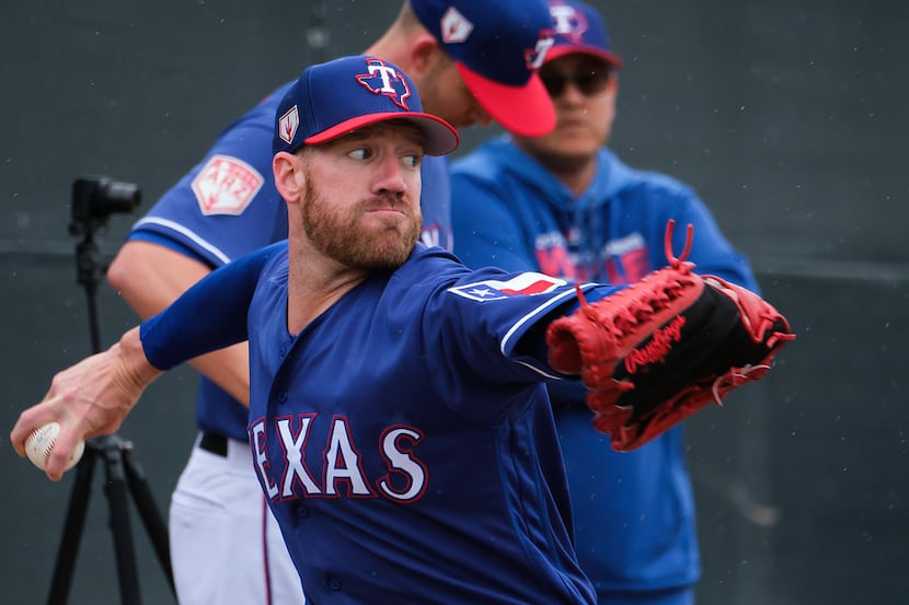 Texas Rangers pitcher Zach McAllister throws a bullpen session during a spring training...