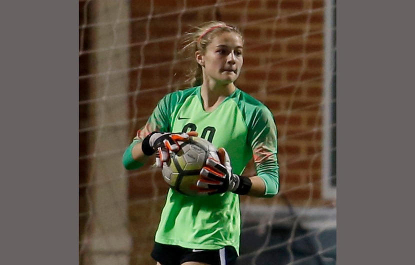 Coppell goalkeeper Lauren Kellett (00) surveys Keller's defensive set as she puts the ball...