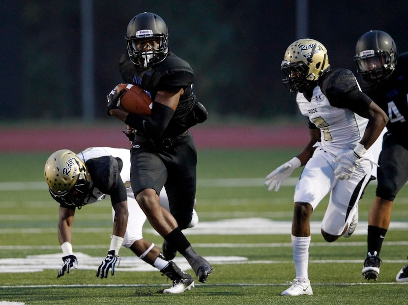 Hebron's Jamal Adams (33) runs up the field for a kickoff return for a touchdown in a game...