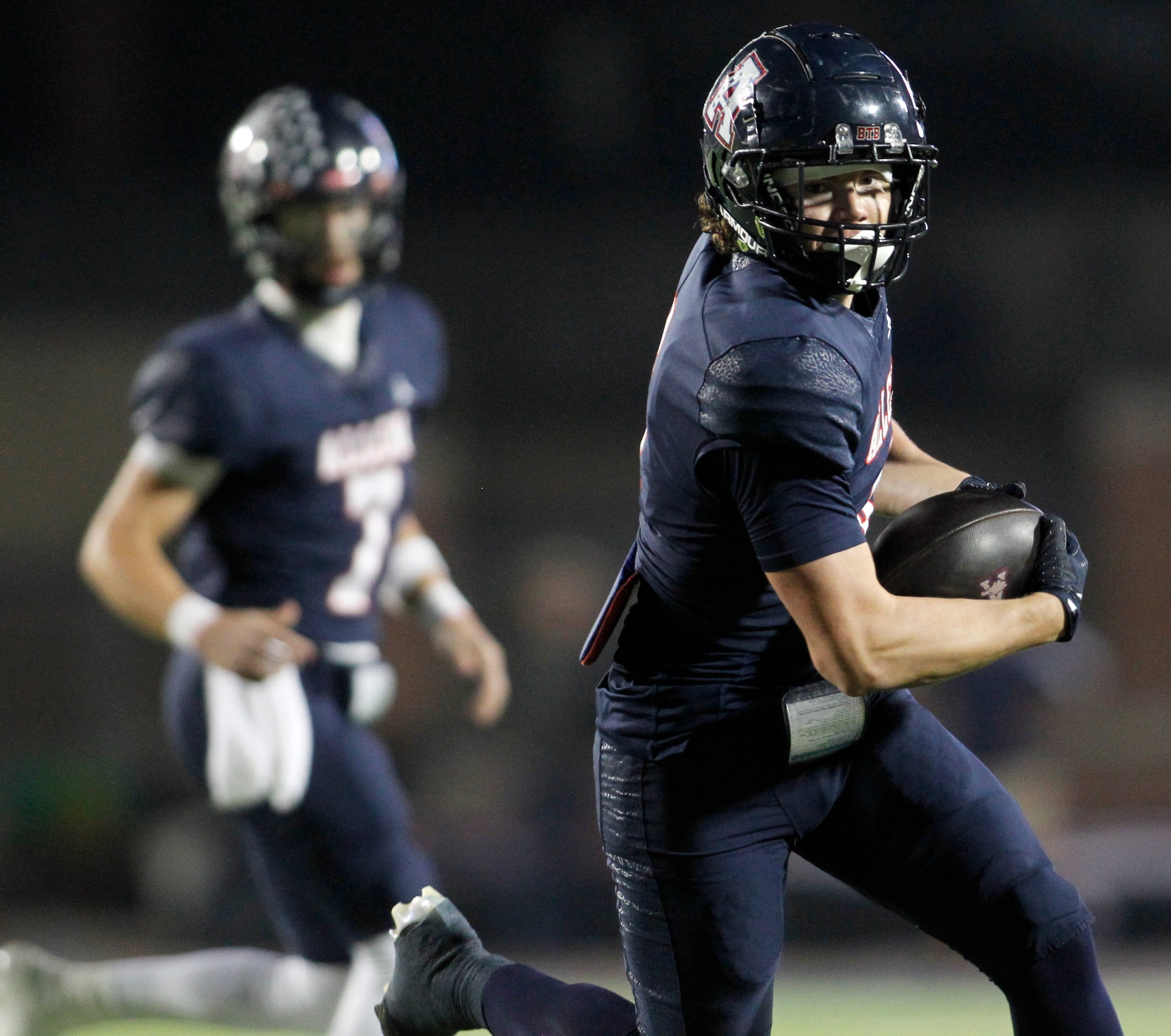 Allen tight end Dustin Kellison (4), right, looks for running room after pulling in a pass...