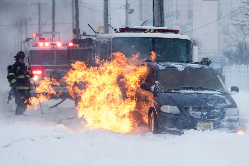 ATLANTIC CITY,  NJ: Firefighters extinguish a vehicle fire during a winter snowstorm in...