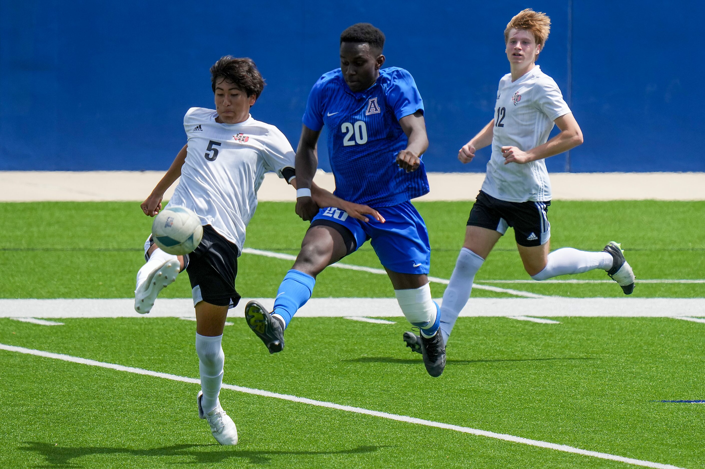 Lake Highlands defender Anthony Licea (5) and Allen forward Osiramah Iyamah (20) fight for...