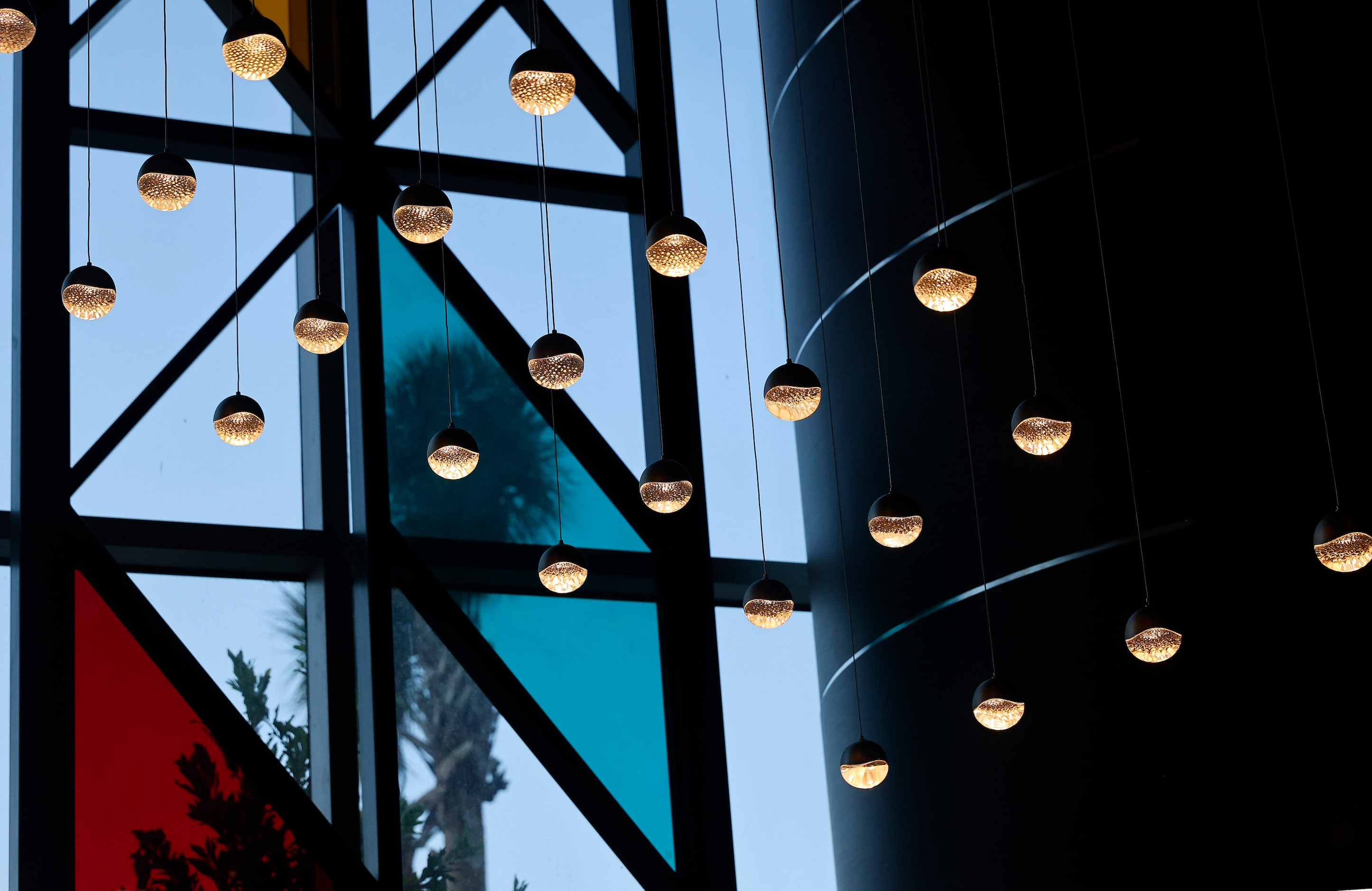 The lobby has stained glass and globe light fixtures.