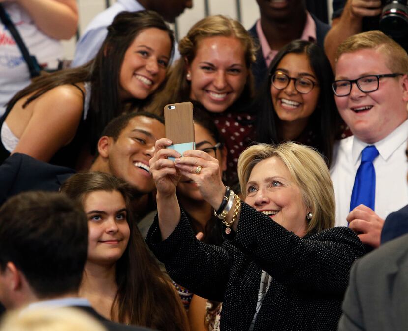 FILE - Democratic presidential candidate Hillary Clinton takes a photo with supporters after...
