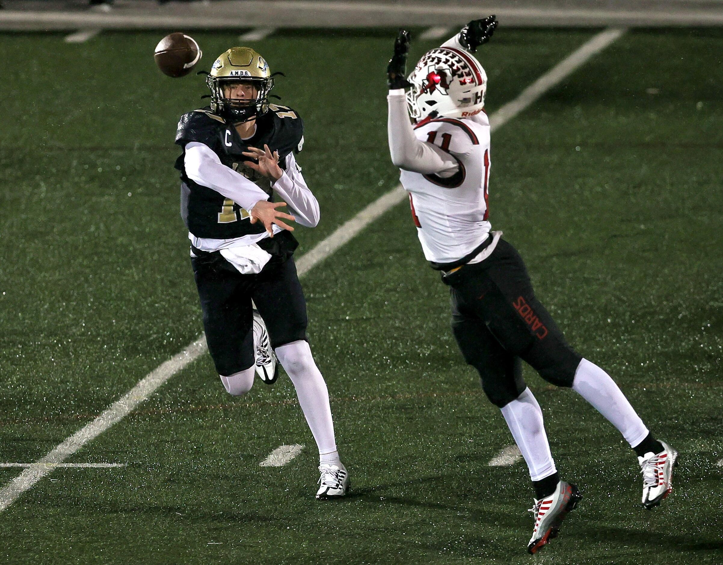 Jesuit quarterback Charlie Schmidt (17) gets off a pass against MacArthur defensive end...