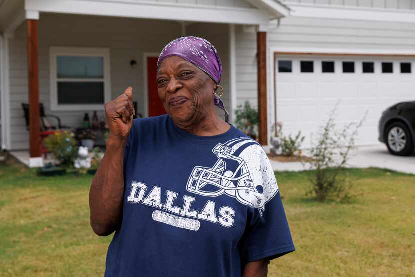 Zeta White gives a thumbs-up outside of her newly constructed home on Sept. 15 in McKinney....