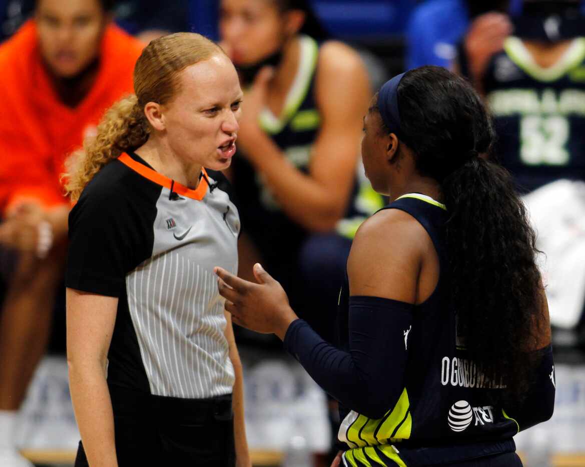 Dallas Wings guard Arike Ogunbowale (24), right, questions a no-call as she converses with a...