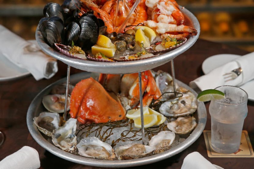 Water Grill's two-tiered deluxe seafood platter, with oysters and clams on the half-shell,...