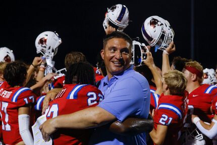 Parish Episcopal’s Head Coach Daniel Novakov, right, embraces Seth Scott (22) as they...