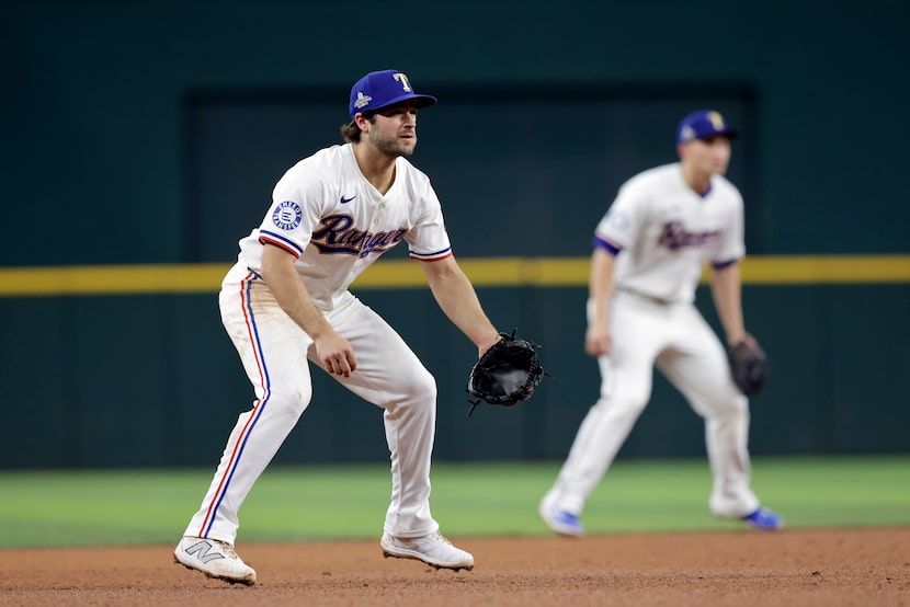 Texas Rangers shortstop Josh Smith (left) and shortstop Corey Seager (right) leap in unison...