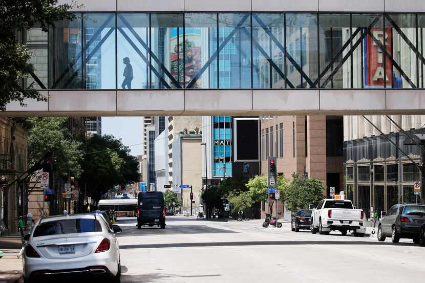 The absence of traffic on Elm Street in downtown Dallas on Tuesday, Aug. 11, shows how the...