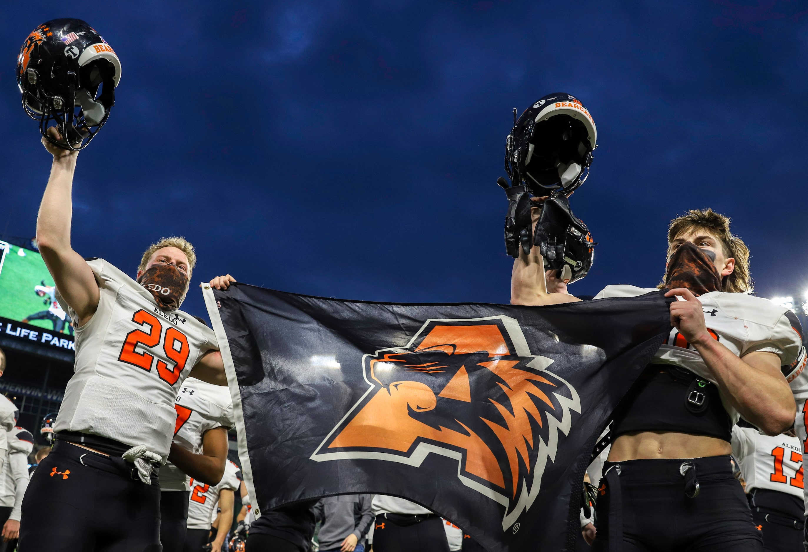 Aledo defensive end Caden Anderson (29) and running back Sammy Steffe (26) raise their...