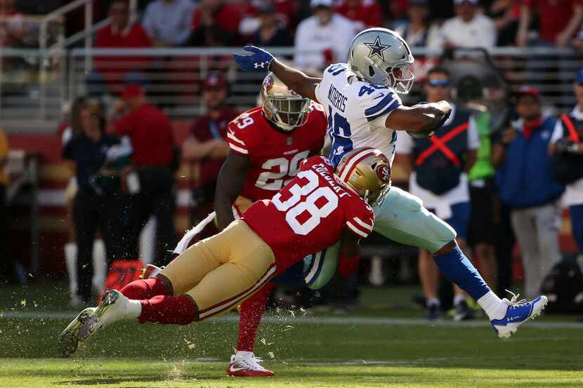 San Francisco 49ers defensive back Adrian Colbert (38) tackles Dallas Cowboys running back...
