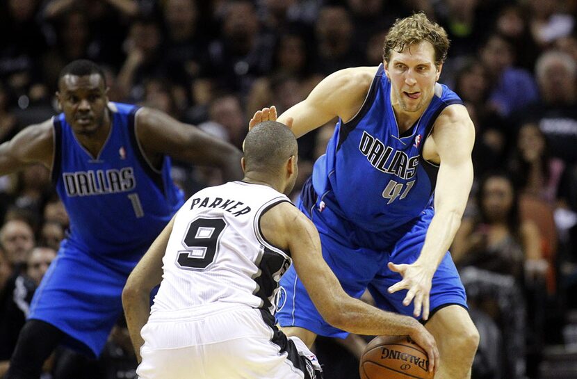 Dallas Mavericks forward Dirk Nowitzki (41) tries to get low and defend San Antonio Spurs...