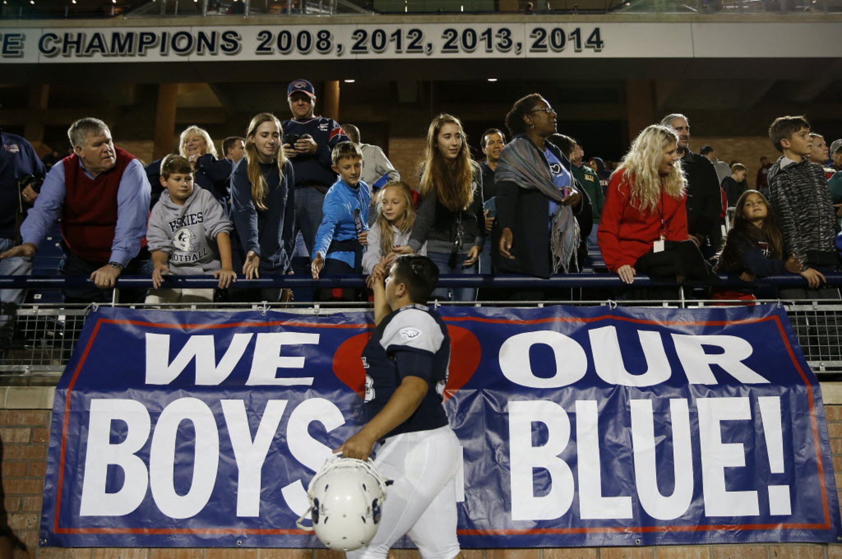 Allen's Rhett Ramos (55) gets a high-five from fans after defeating Plano East 58-23 at...