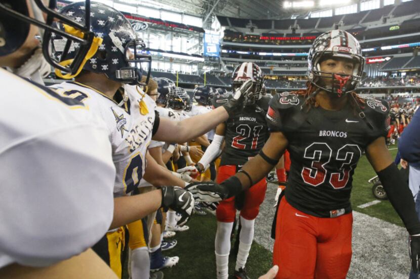 Highland Park players shake hands with Mansfield Legacy players, including Everett Williams...