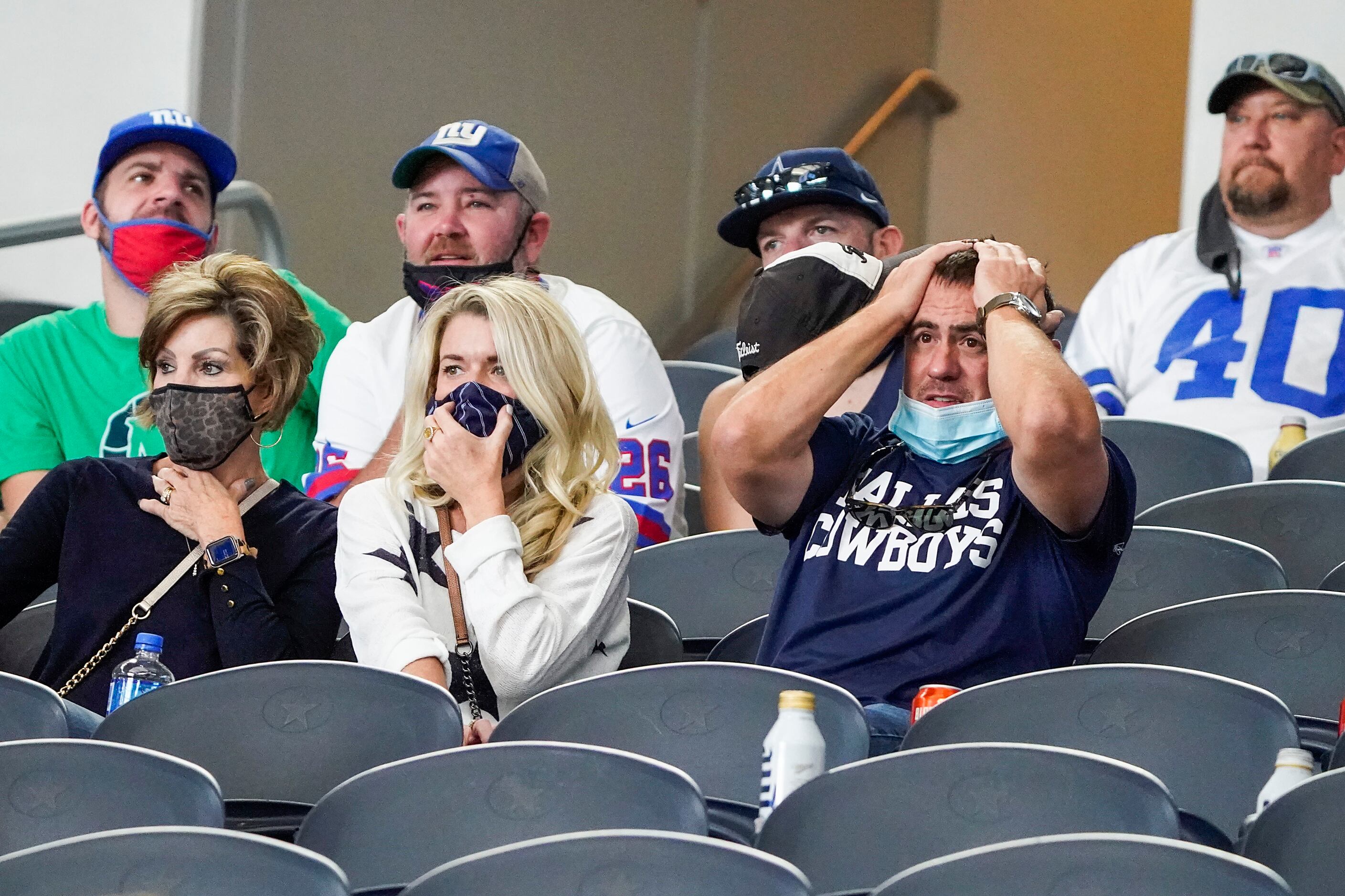Dallas Cowboys fans react after quarterback Dak Prescott was injured on a tackle by New York...