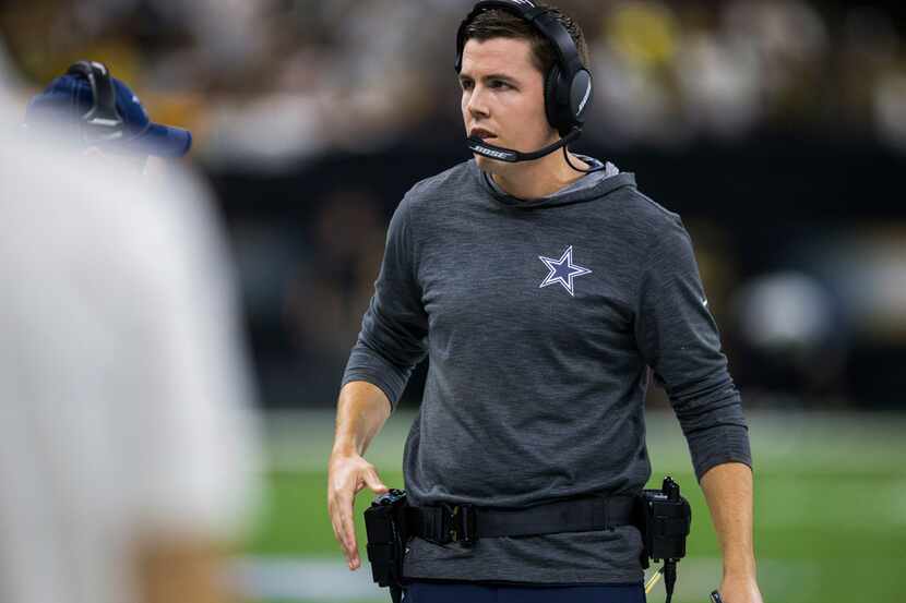 Dallas Cowboys offensive coordinator Kellen Moore walks on the sideline during the first...