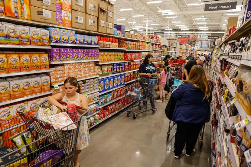 Customers grocery shop at the new H-E-B that opened at 6 a.m. in Frisco on Wednesday.