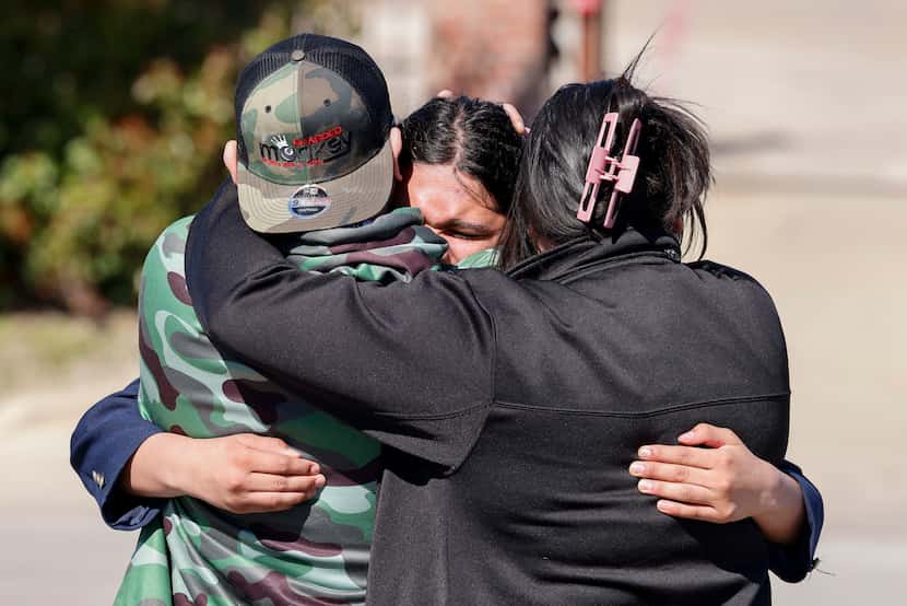 Pioneer Technology and Arts Academy student Aiden Martinez, 15, hugs his father, Jose...