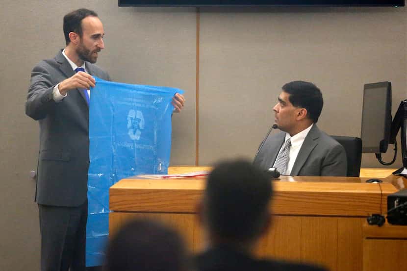 Prosecutor Jason Fine cross-examines Wesley Mathews in court Wednesday, showing him a blue...