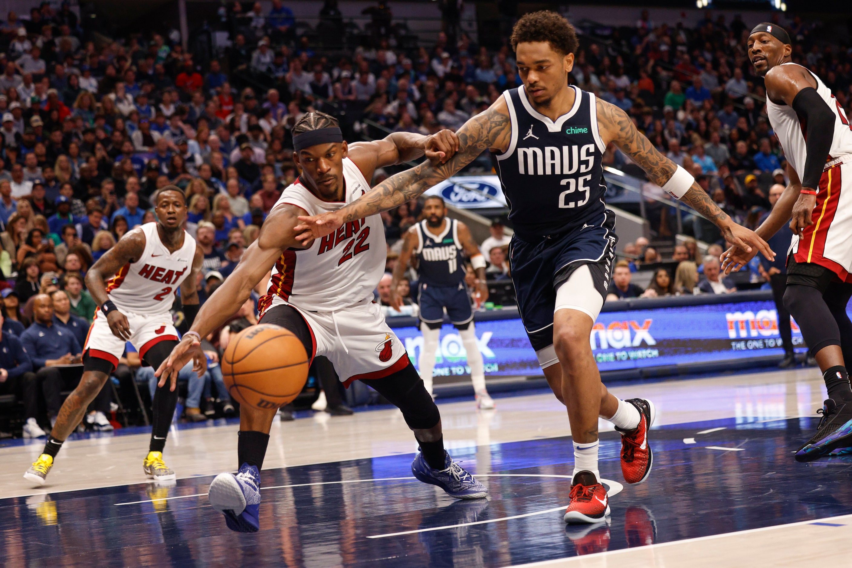 Miami Heat forward Jimmy Butler (22) stretches to save the ball ahead of Dallas Mavericks...