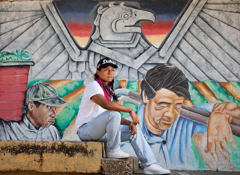 Indigenous organizer Rogelio “Rojo” Meixueiro poses for a photo in front of a mural painting...