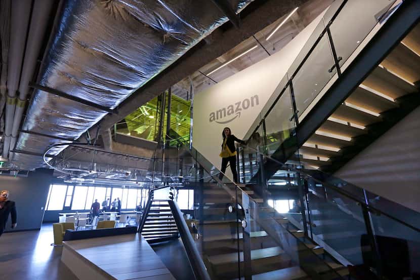 An Amazon worker walks down steps in the company's Seattle office.