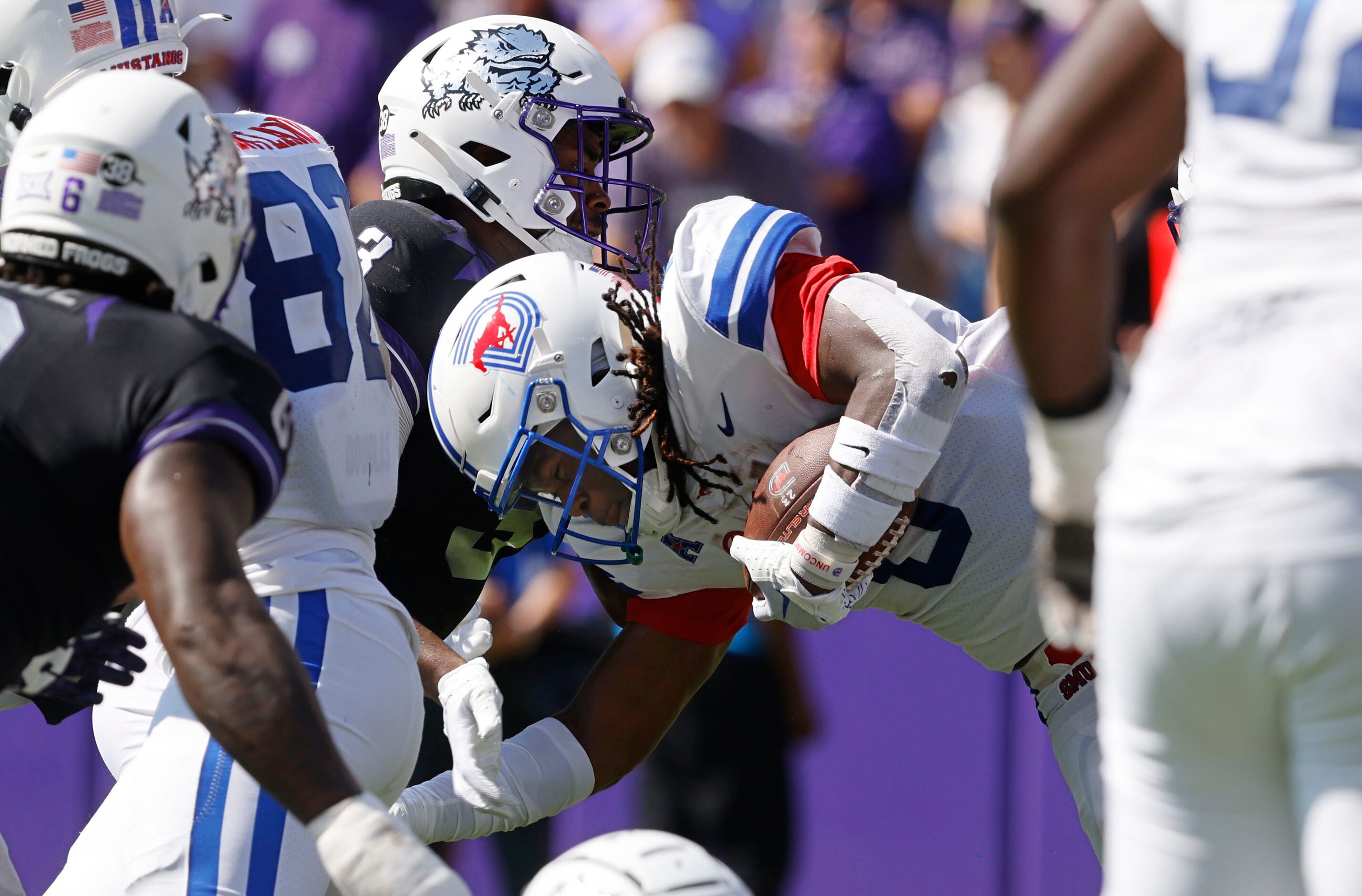 Southern Methodist Mustangs running back Camar Wheaton (0) is tackled by TCU Horned Frogs...