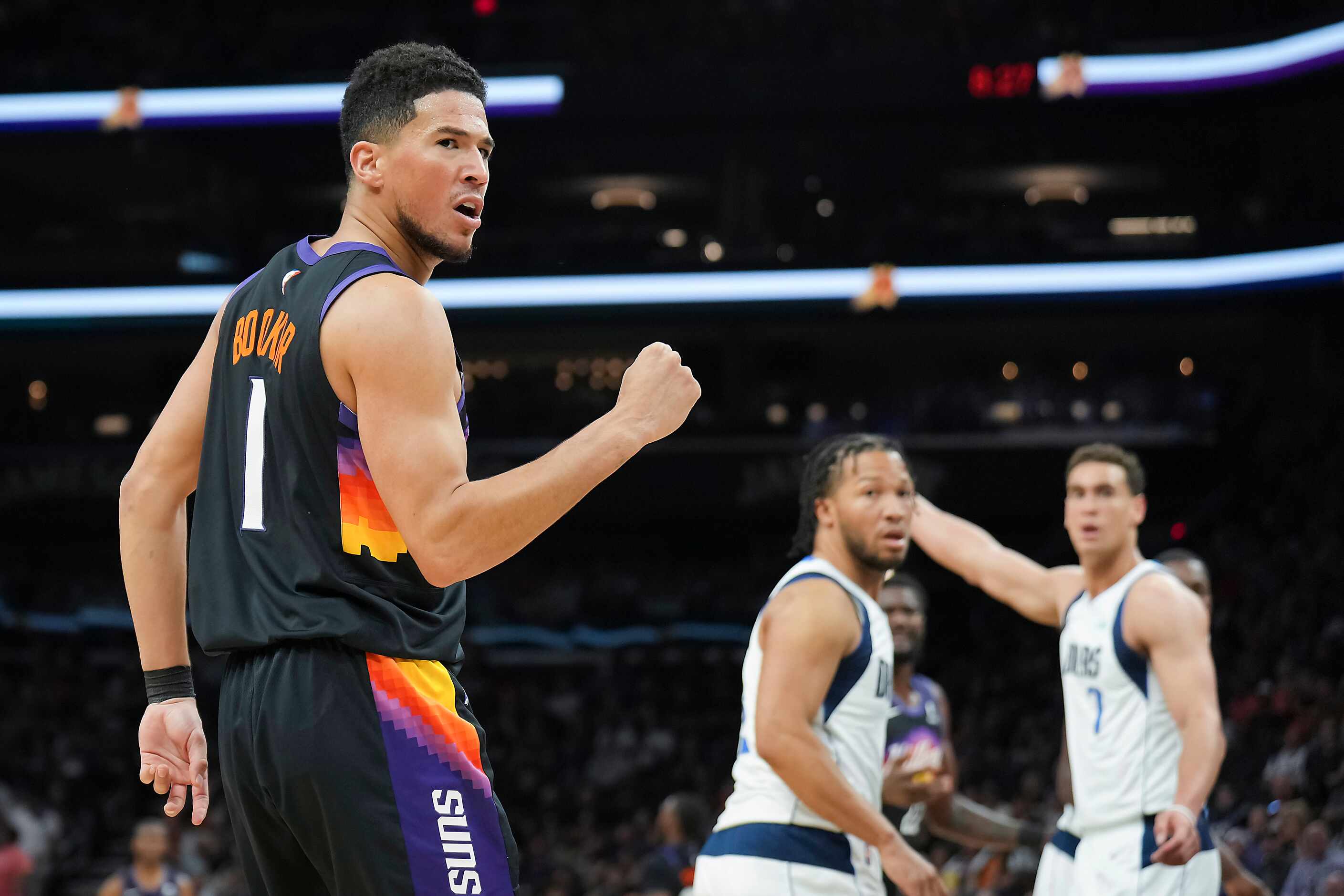 Phoenix Suns guard Devin Booker (1) celebrates after an offensive foul call against the...