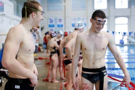 Keller high swimmer Maximus Williamson (left) reacts towards River Paulk during a swim and...