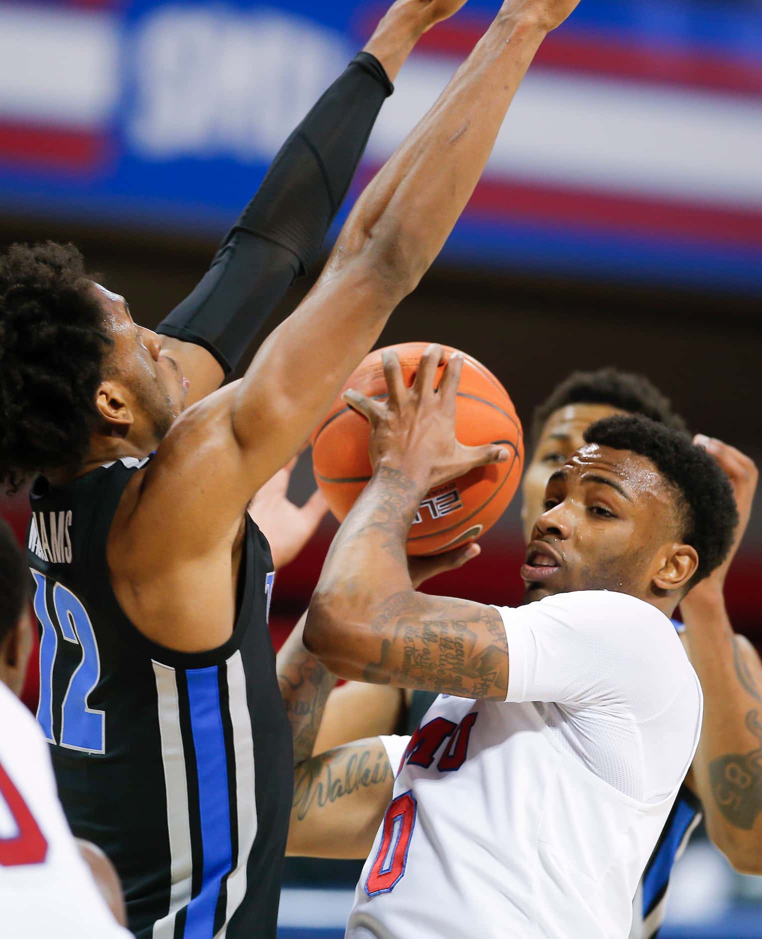 SMU guard Tyson Jolly (0) battles Memphis forward DeAndre Williams (12) for space during the...