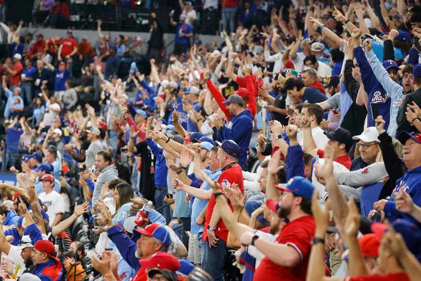 Fans cheers during a home run by Texas Rangers outfielder Robbie Grossman during the fourth...