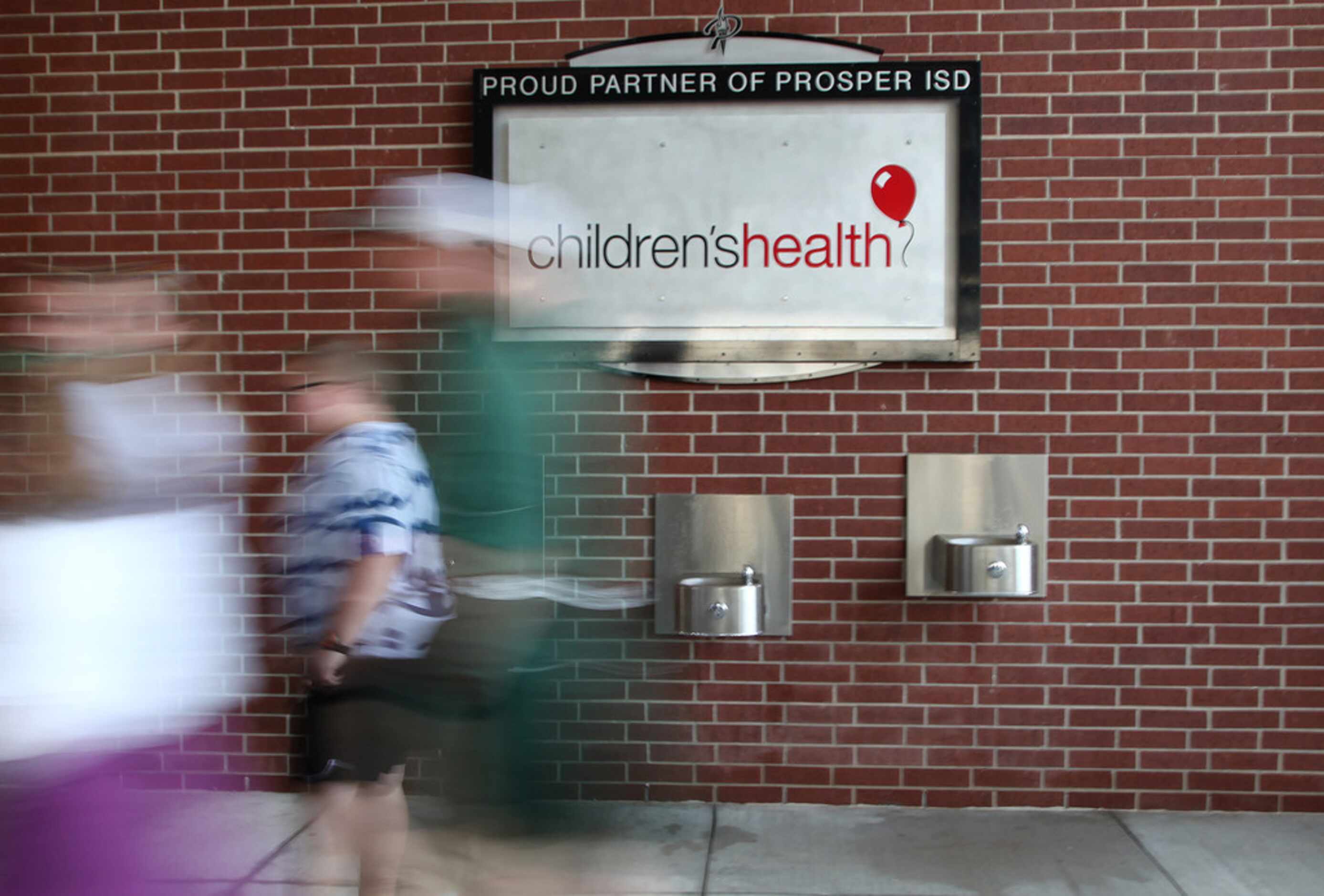 Fans walk into the new Childrenâs Health Stadium before kickoff as Prosper High School...