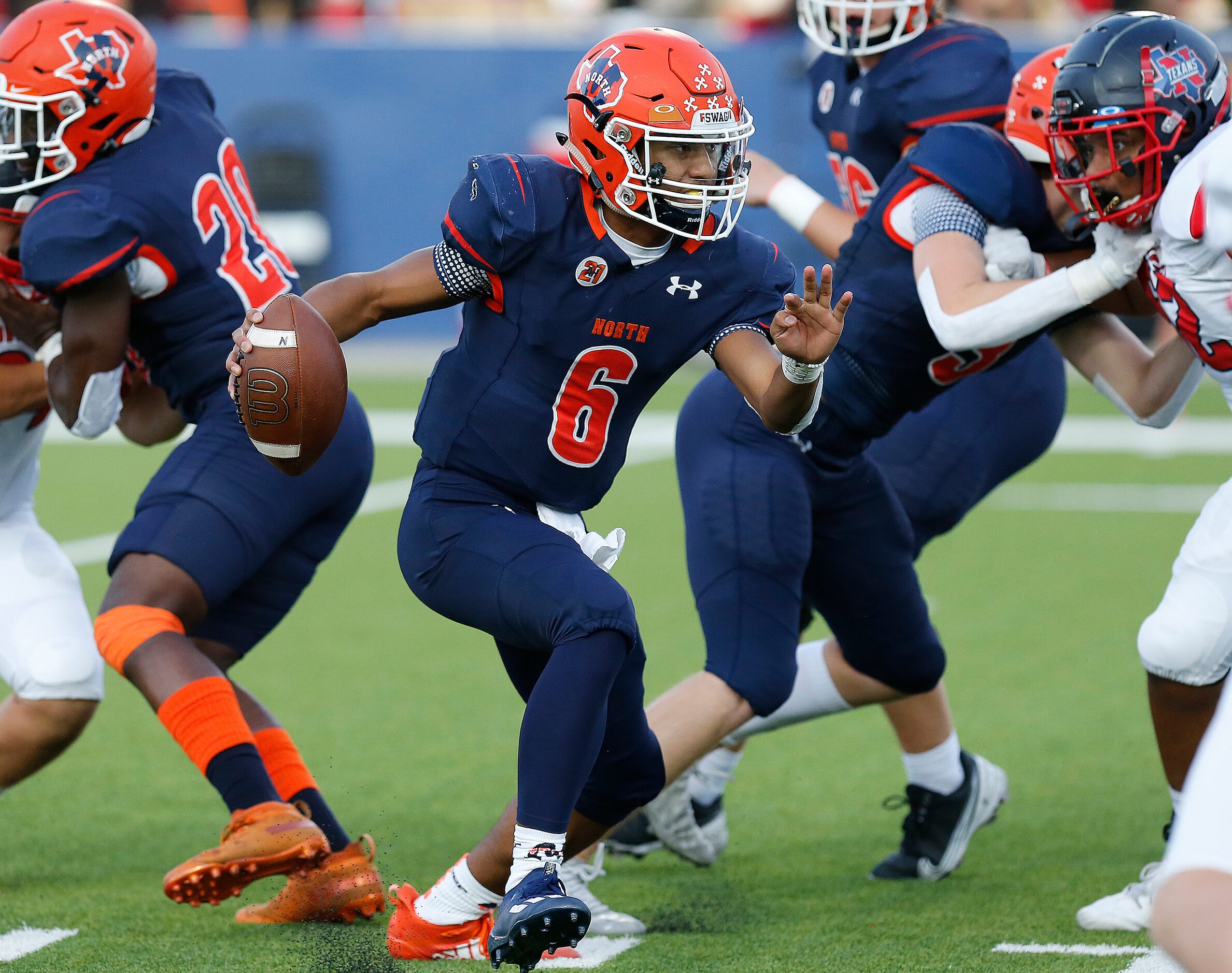 McKinney North High School quarterback Gavin Constantine ll (6) scrambles during the first...