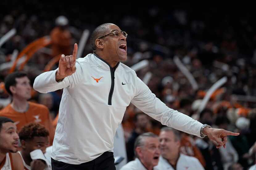 Texas interim coach Rodney Terry signals to players during the first half of the team's NCAA...