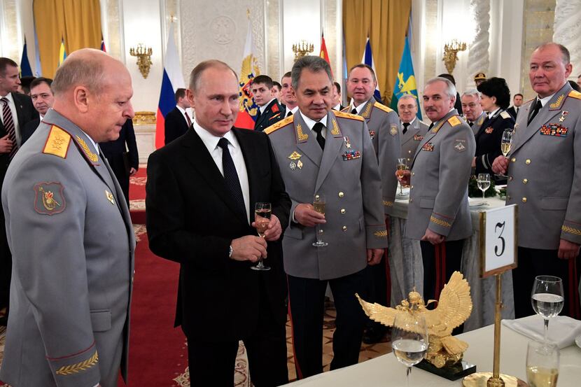 Russian President Vladimir Putin, 2nd left, and Defence Minister Sergei Shoigu, center,...