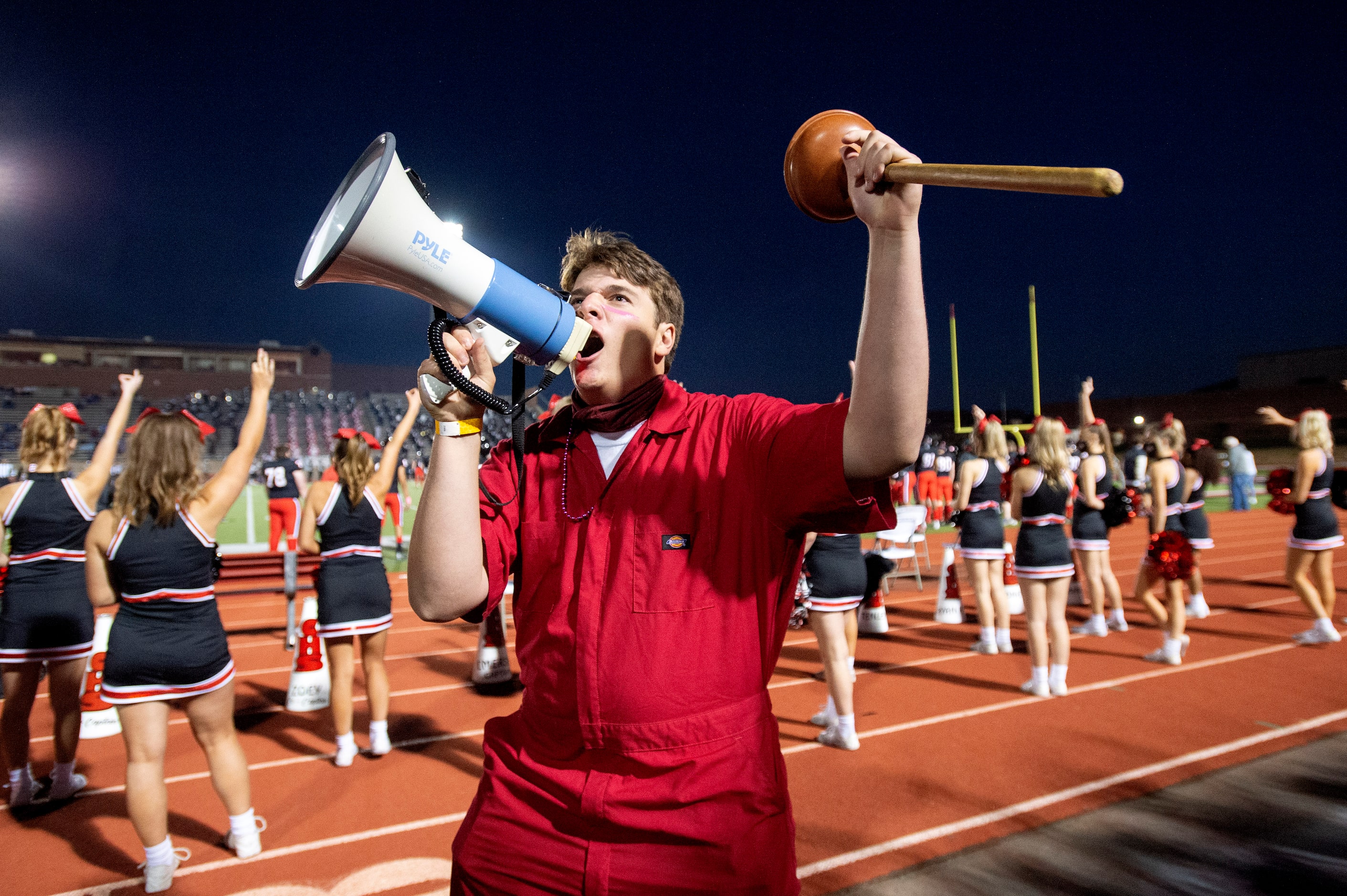 Coppell senior Plunger Boy Ryan Tompkins fires up the crowd during the first half of a high...