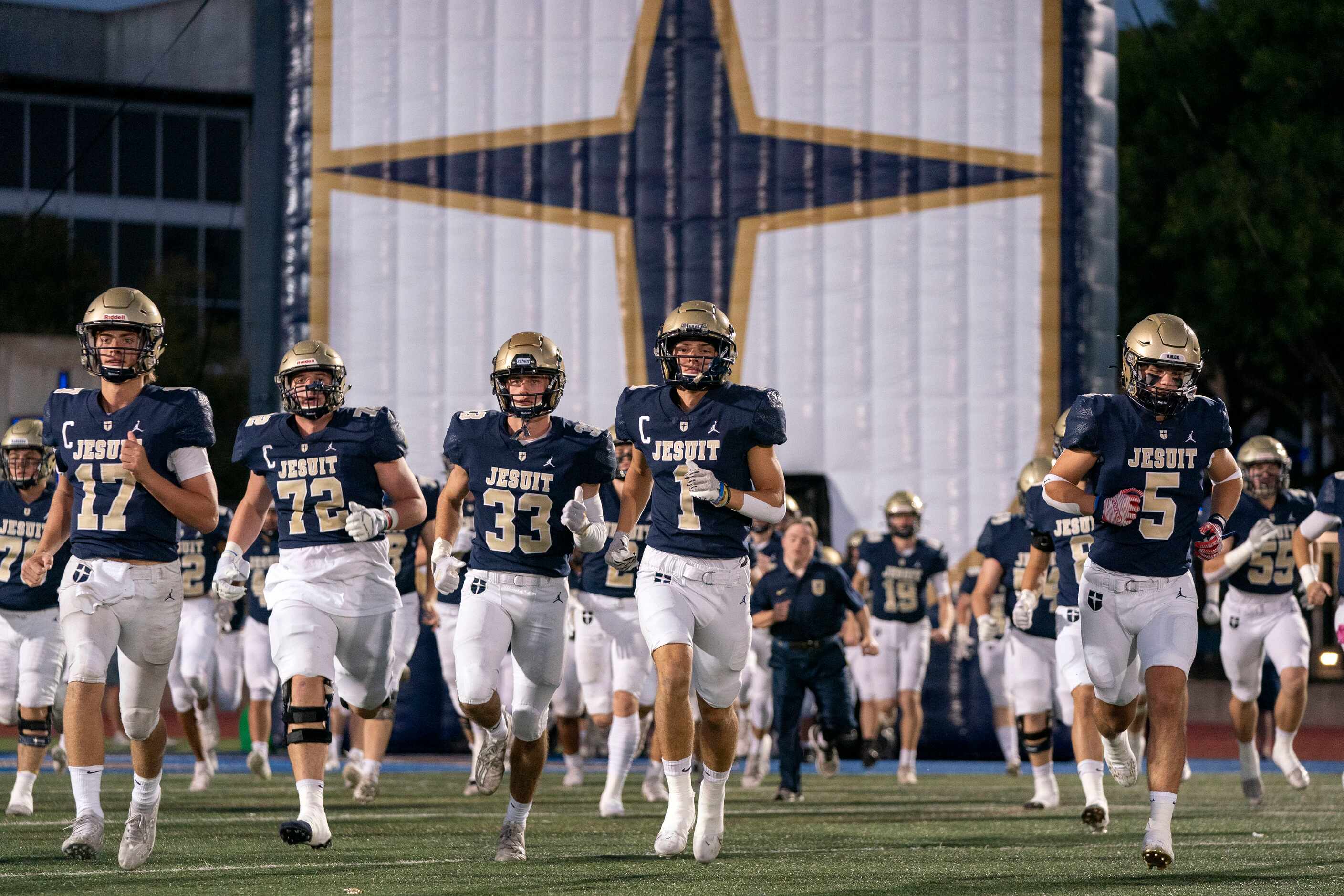 The Jesuit Rangers take the field before a high school football game against Richardson...