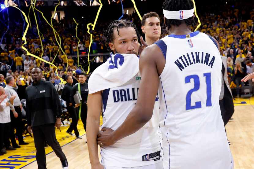 Dallas Mavericks guard Jalen Brunson (13) and Frank Ntilikina (21) hug following their Game...