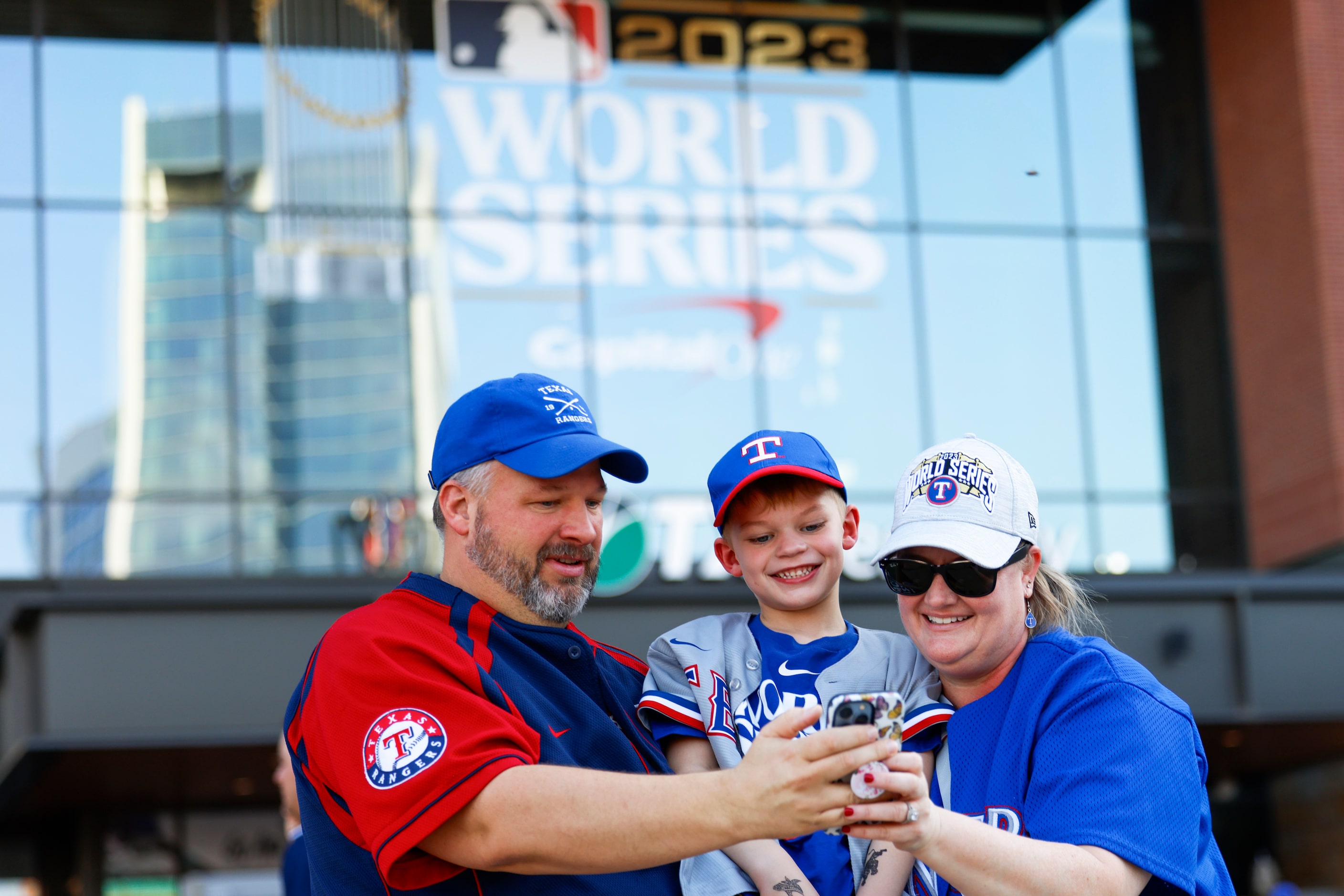 From left, Henry, Jack, 6, and Jennifer Holland, prepare to take selfie outside of Globe...