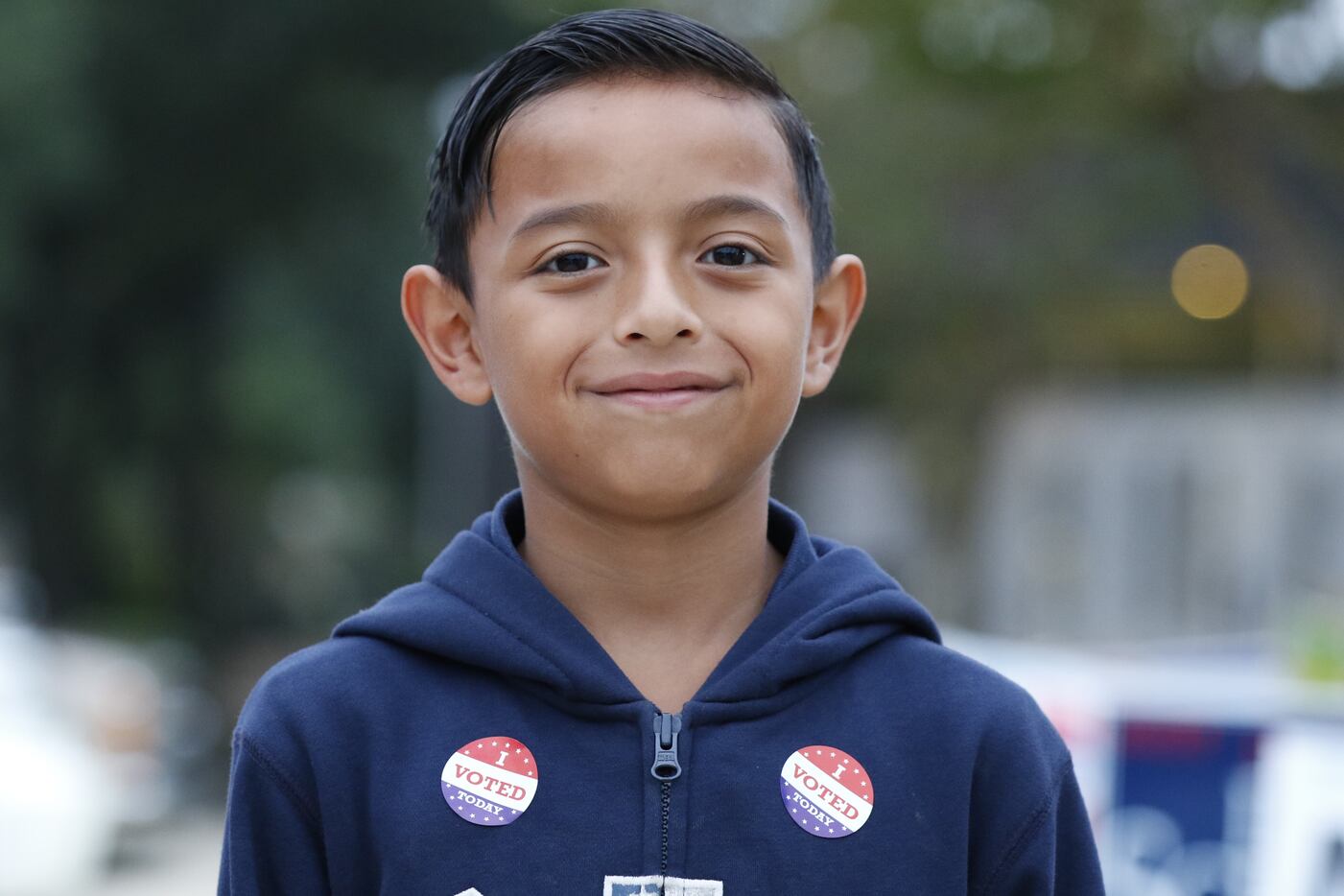 Nathan Cruz, 8, is all smiles after watching his father Sergio Cruz vote early at the Dallas...