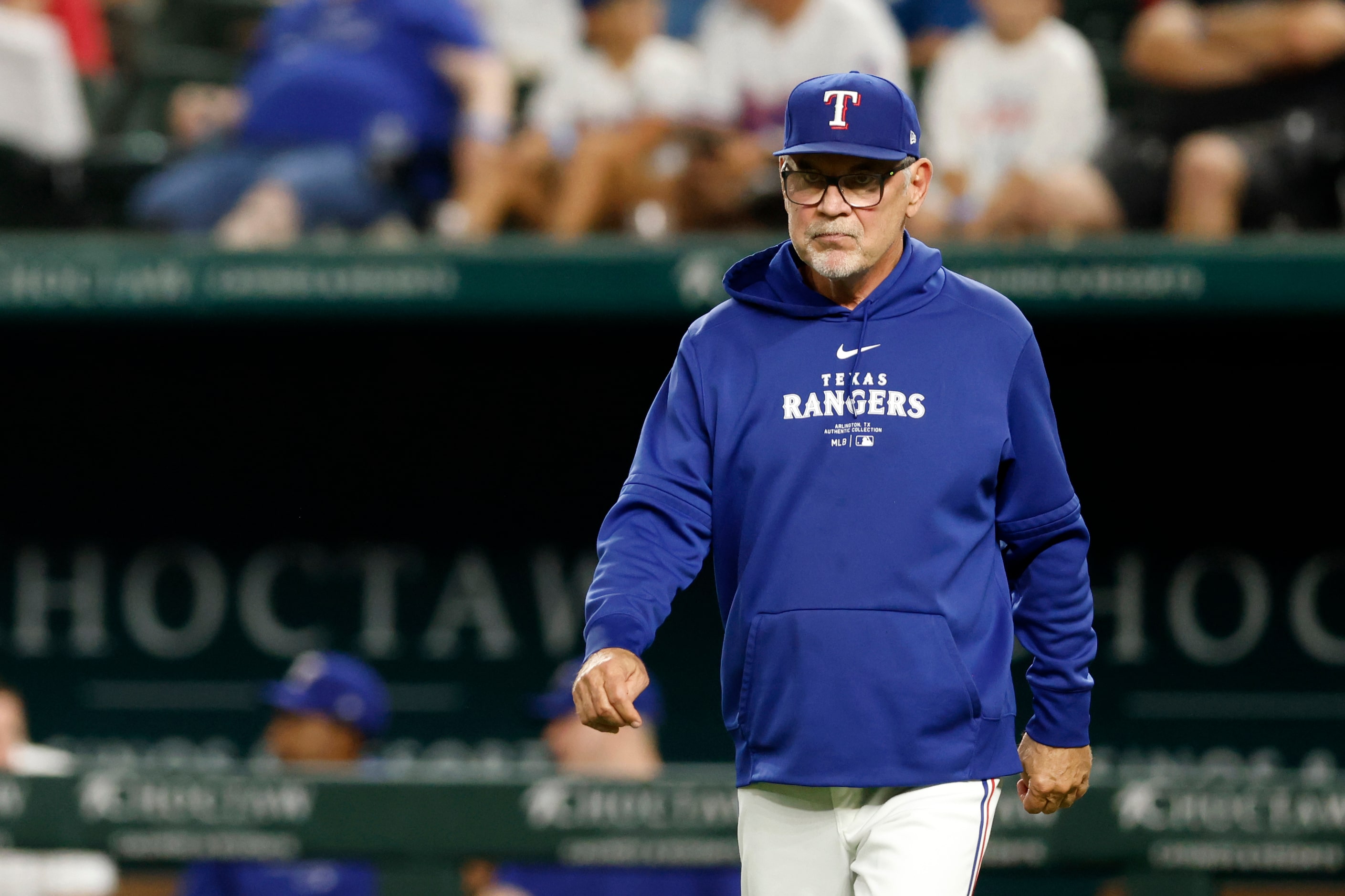 Texas Rangers manager Bruce Bochy heads to the mound to make a pitching change during the...